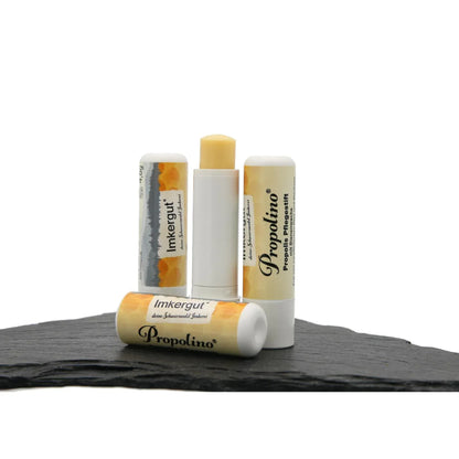 Mehrere Propolino Lippenpflegestifte auf einer Schieferplatte